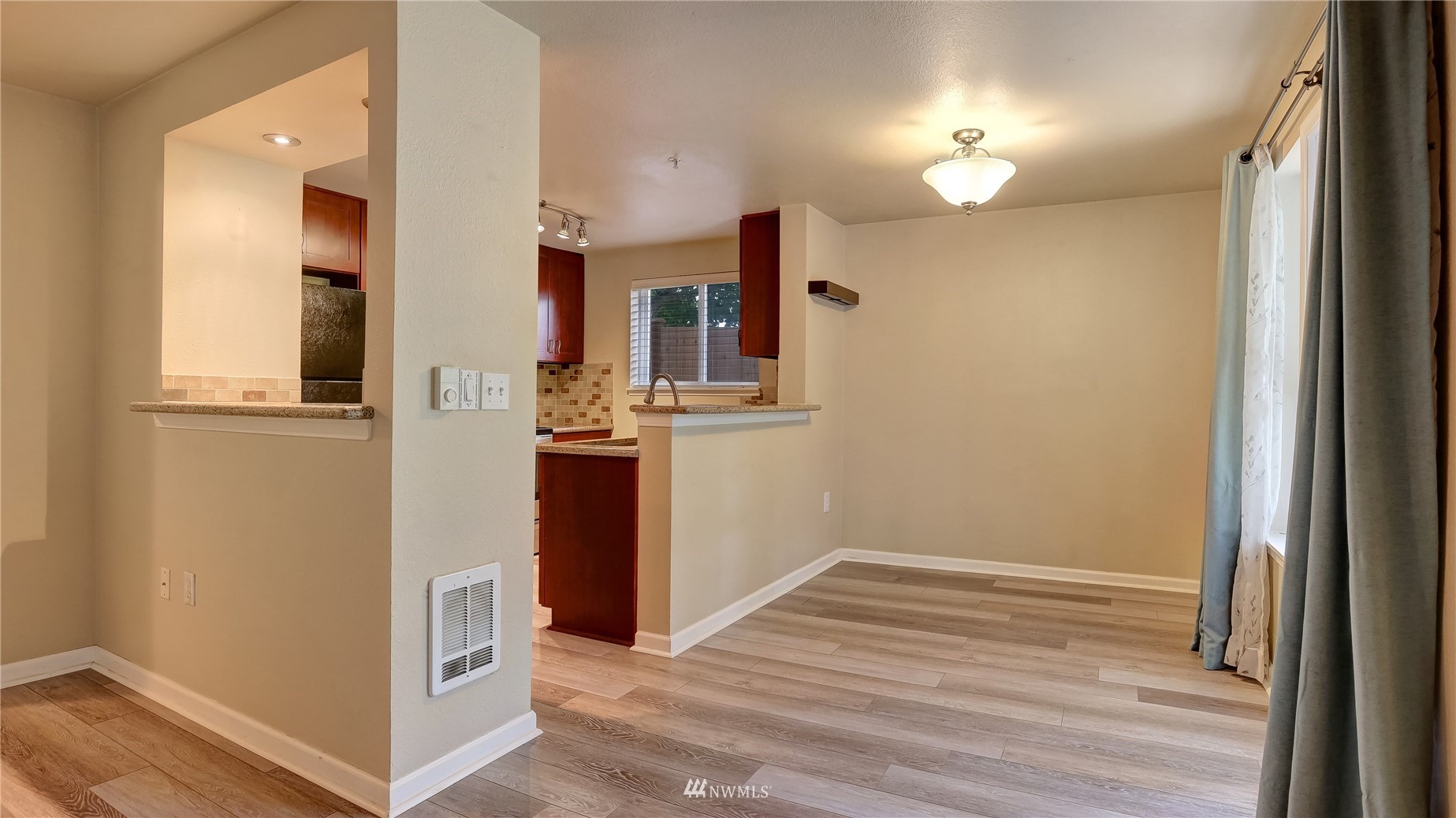 11002 Southeast Petrovitsky Road, Unit H101 Renton, WA 98055 - Photo 10 of 30 a view of a kitchen from the hallway