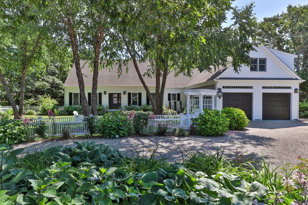a front view of a house with a garden