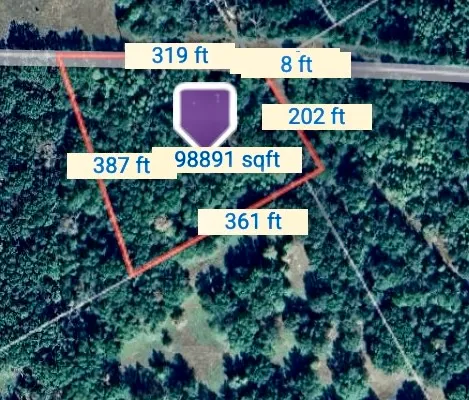 a sign that is sitting in front of flowers