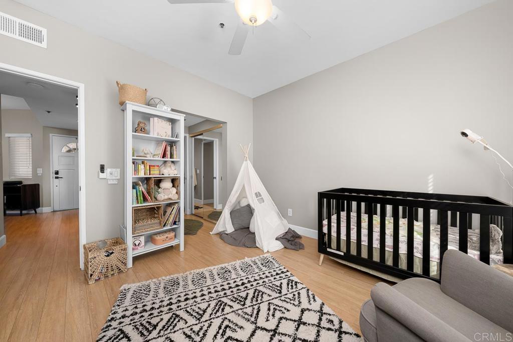 3666 Third Avenue, Unit 202 San Diego, CA 92103 - Photo 11 of 31 a living room with a couch and a book shelf