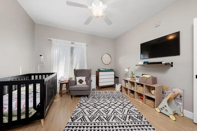a bedroom with furniture and a flat screen tv