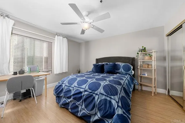a bedroom with a bed and wooden floor