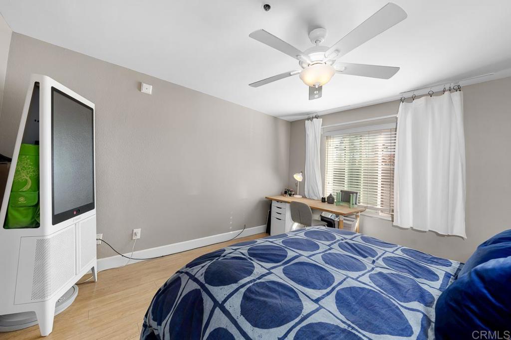 3666 Third Avenue, Unit 202 San Diego, CA 92103 - Photo 16 of 31 a bedroom with a bed and a chandelier