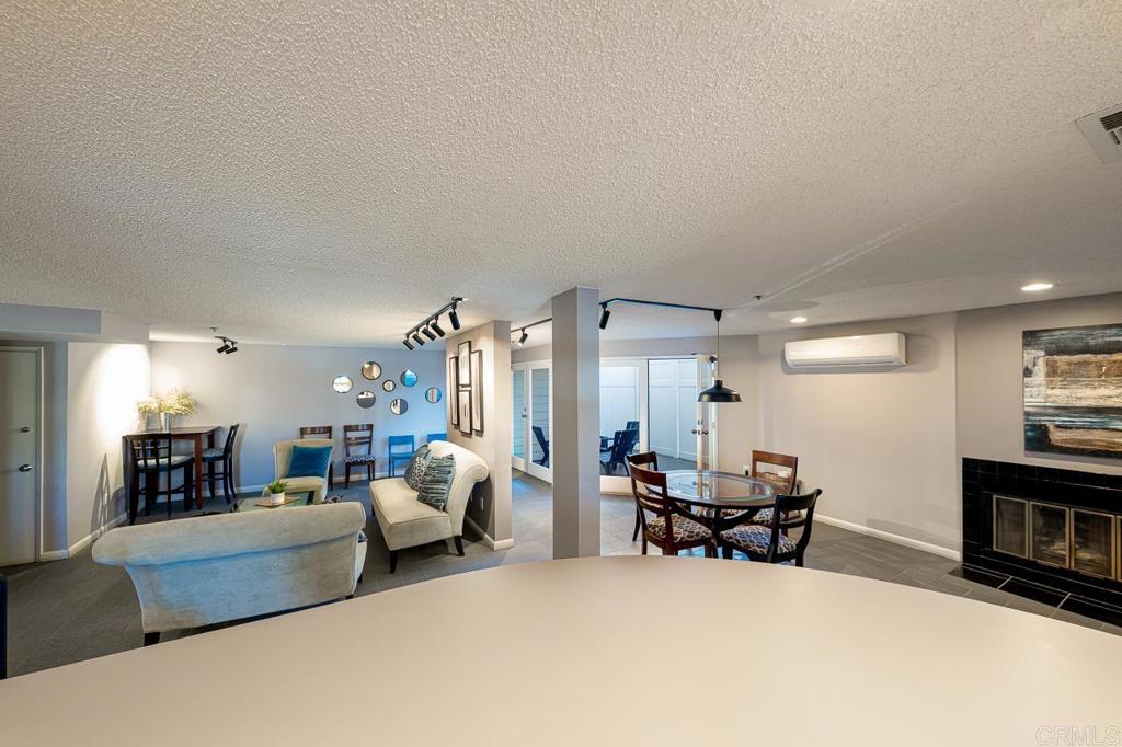 3666 Third Avenue, Unit 202 San Diego, CA 92103 - Photo 24 of 31 a living room with furniture and a dining table with kitchen view