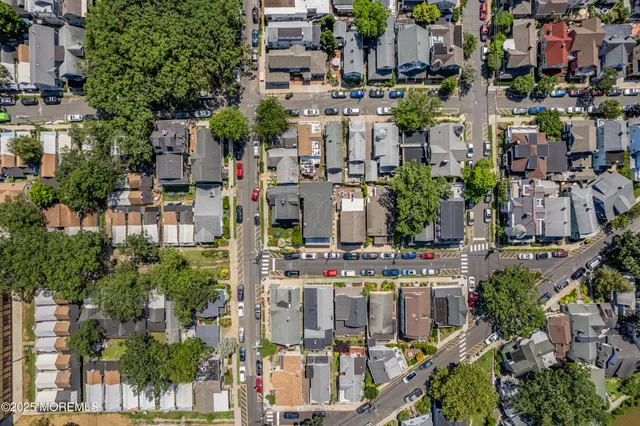 an aerial view of residential houses with city view