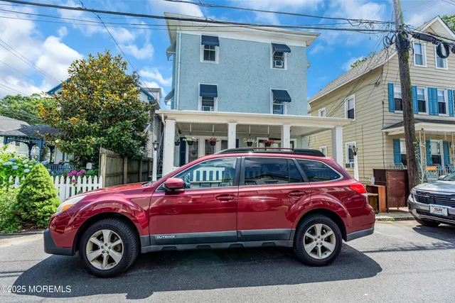 a front view of a house with parking space