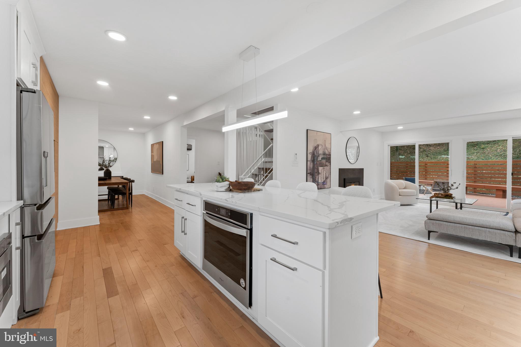 6522 Walhonding Road Bethesda, MD 20816 - Photo 11 of 76 a large kitchen with stainless steel appliances granite countertop a lot of counter space and wooden floors