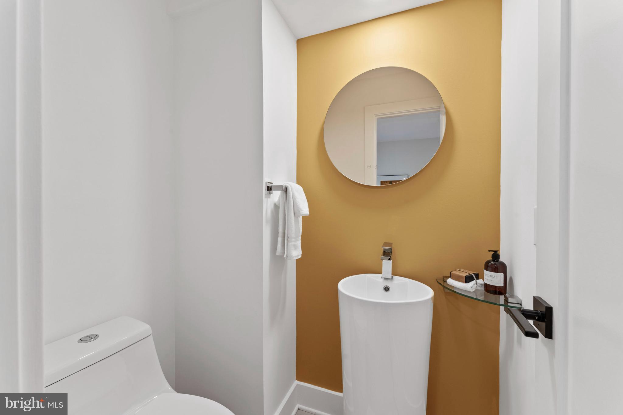 6522 Walhonding Road Bethesda, MD 20816 - Photo 18 of 76 a bathroom with a toilet and a mirror