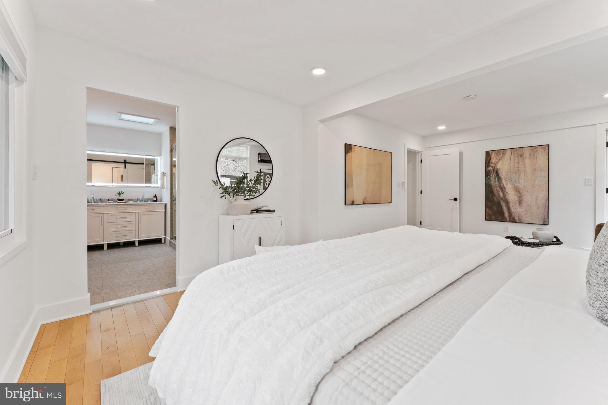 6522 Walhonding Road Bethesda, MD 20816 - Photo 23 of 76 a spacious bedroom with a bed and a large mirror