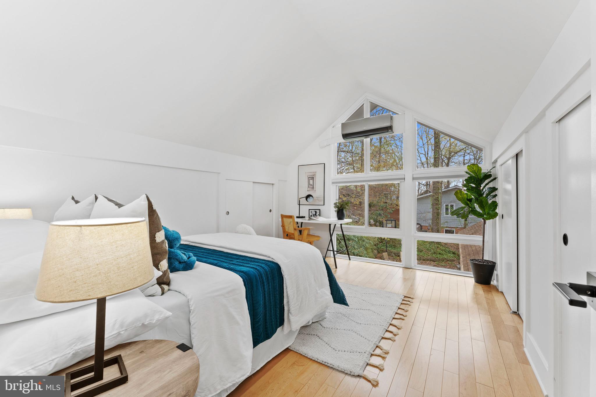 6522 Walhonding Road Bethesda, MD 20816 - Photo 39 of 76 a bedroom with a bed and a lamp on table