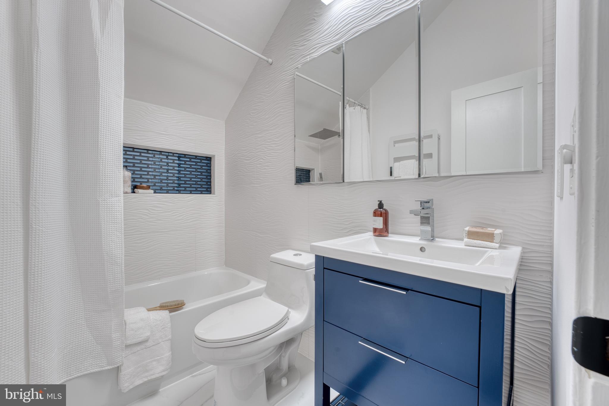 6522 Walhonding Road Bethesda, MD 20816 - Photo 40 of 76 a bathroom with a sink toilet and mirror