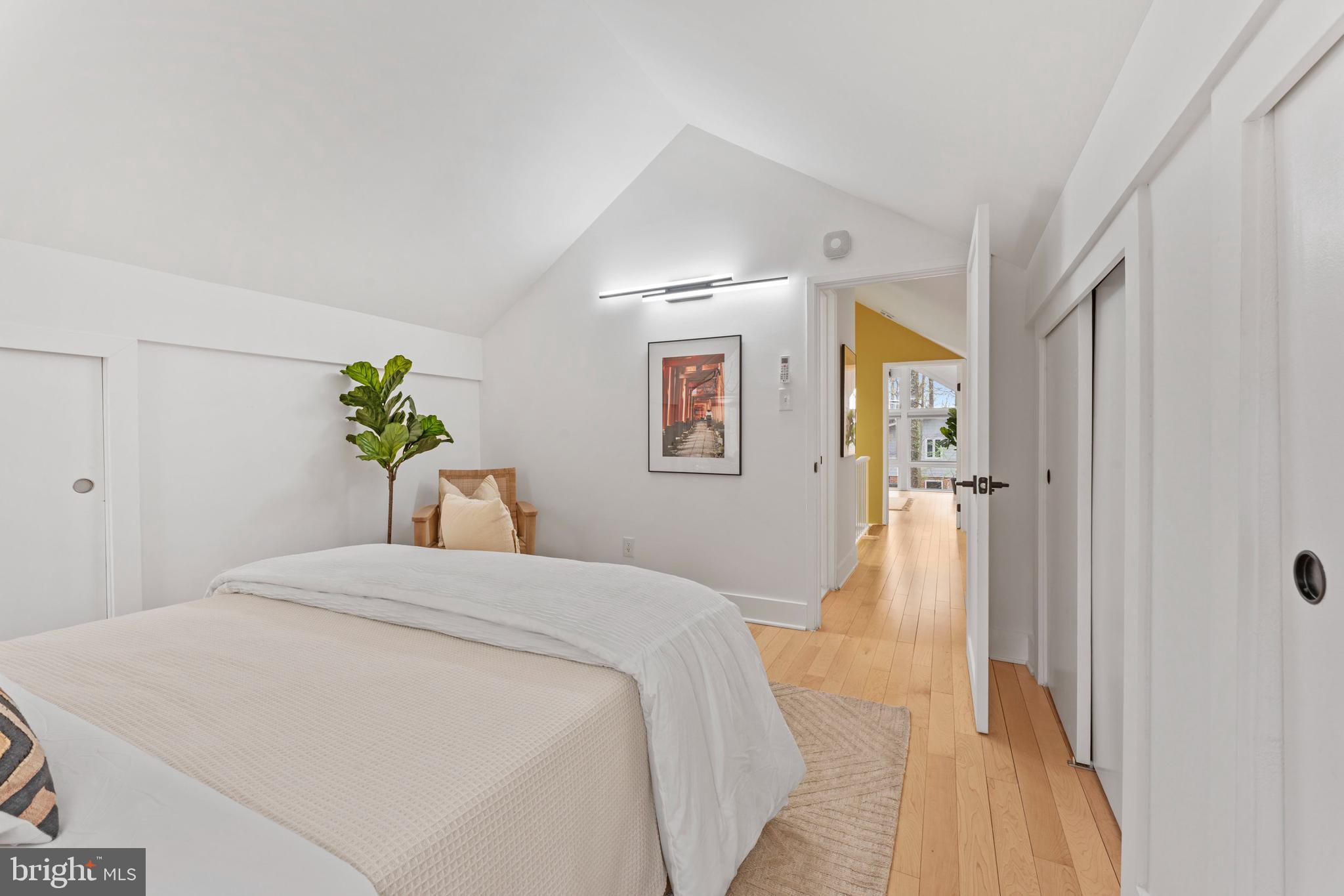 6522 Walhonding Road Bethesda, MD 20816 - Photo 44 of 76 a bedroom with a bed and a potted plant