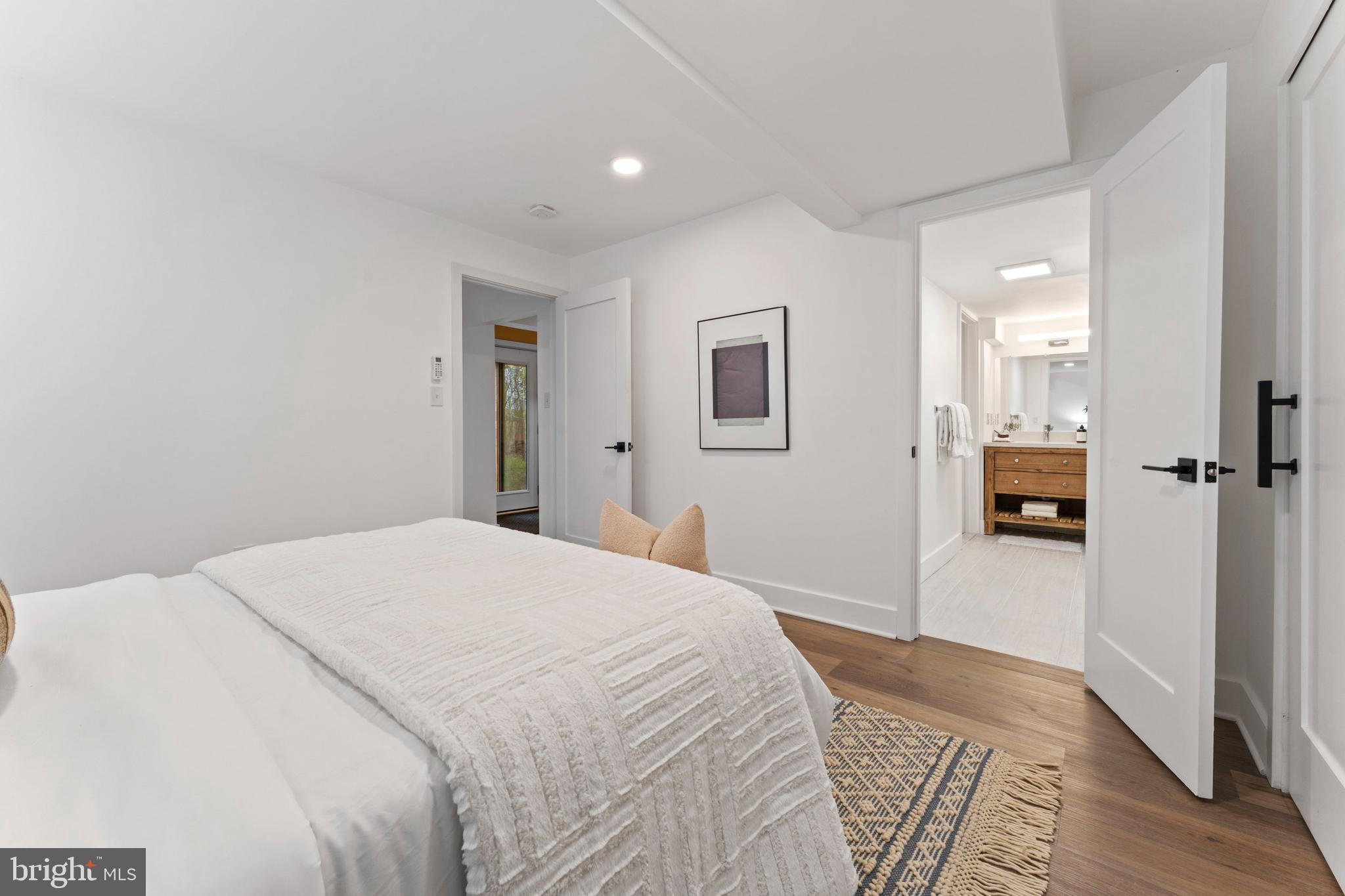 6522 Walhonding Road Bethesda, MD 20816 - Photo 54 of 76 a bedroom with a bed and wooden floor