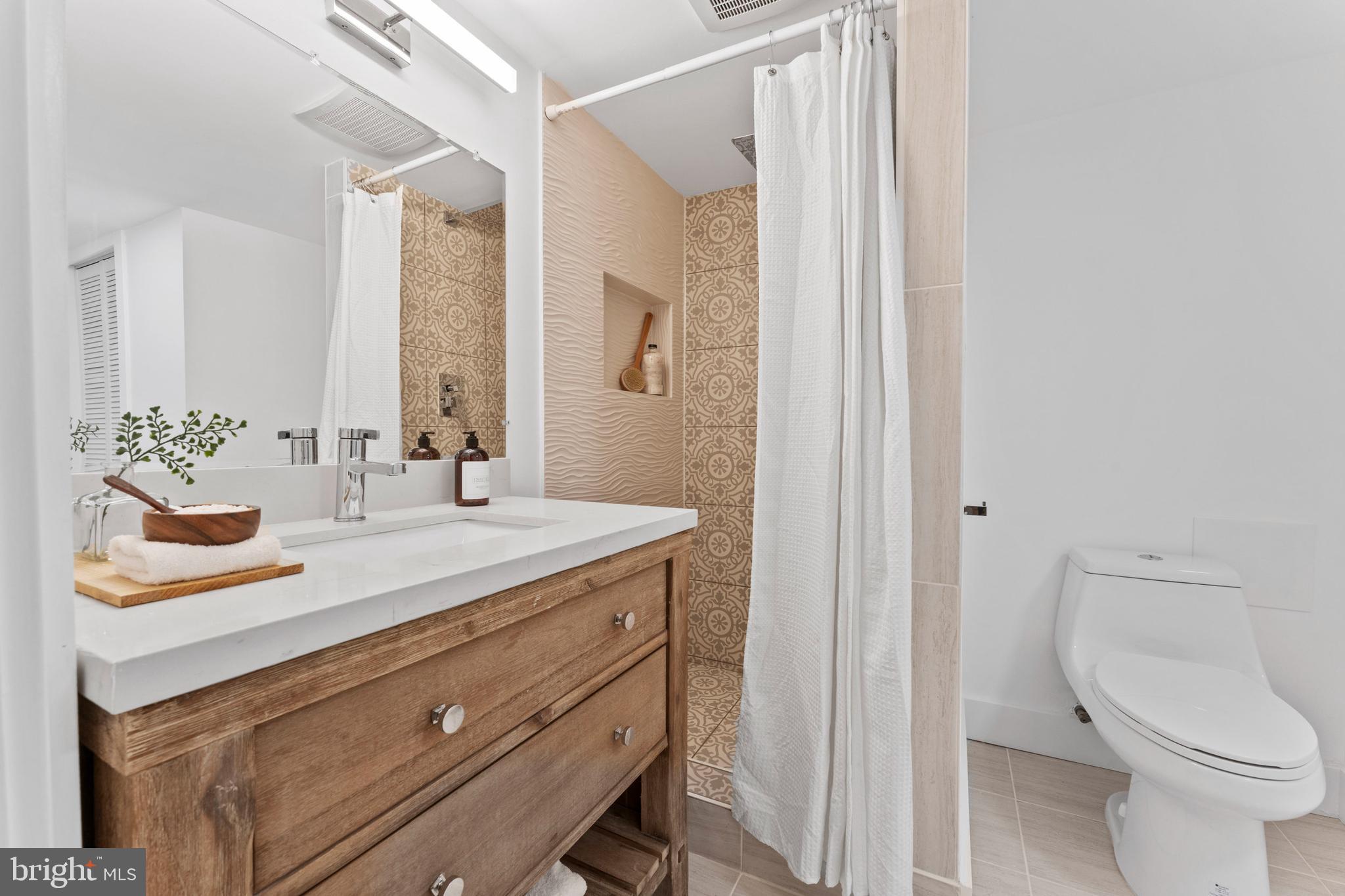6522 Walhonding Road Bethesda, MD 20816 - Photo 55 of 76 a bathroom with a sink a toilet and a mirror