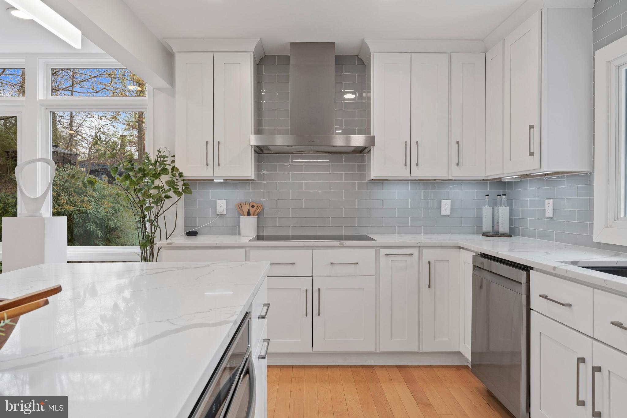 6522 Walhonding Road Bethesda, MD 20816 - Photo 9 of 76 a kitchen with white cabinets and sink