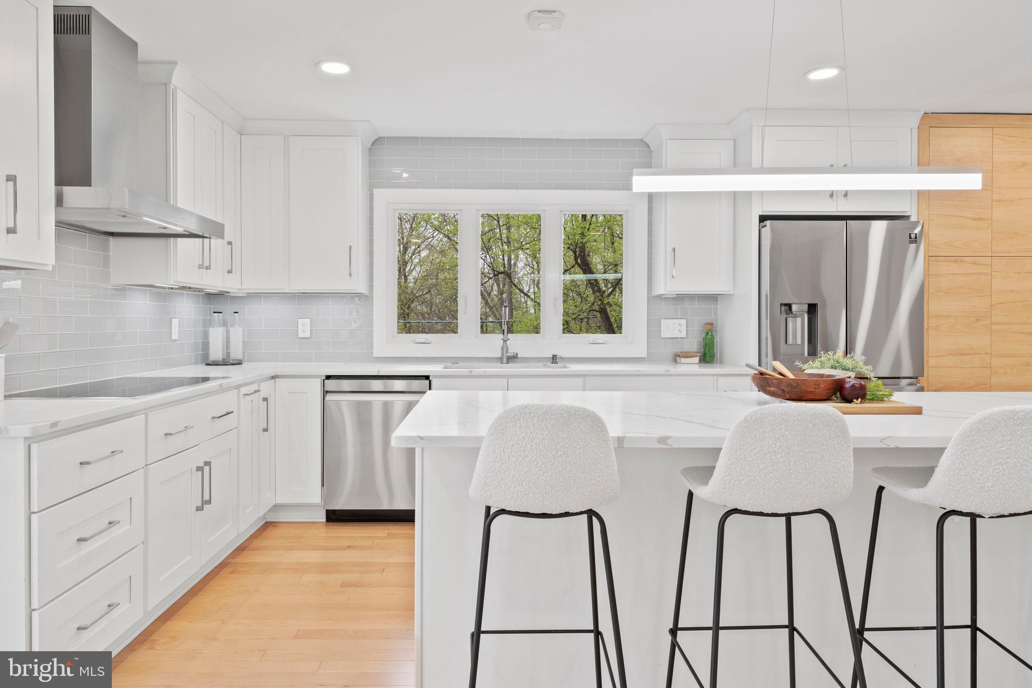 6522 Walhonding Road Bethesda, MD 20816 - Photo 10 of 76 a kitchen with stainless steel appliances a sink window and cabinets