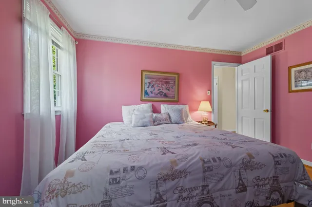 a bedroom with a bed couch and a dresser