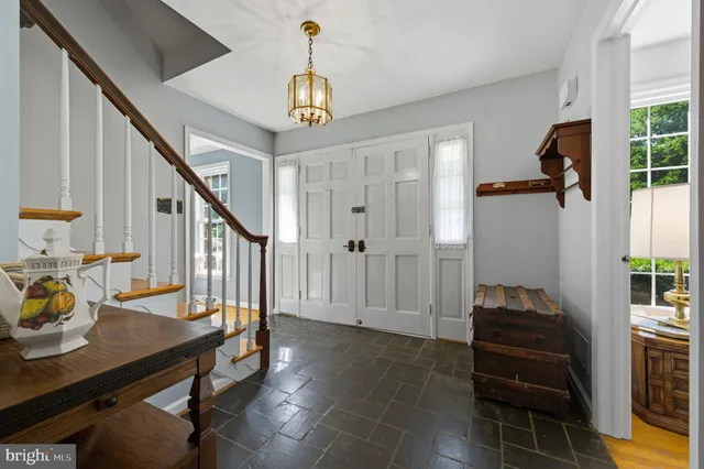 a view of entryway and hall with wooden floor
