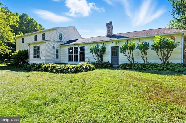 a view of green field with trees in the background
