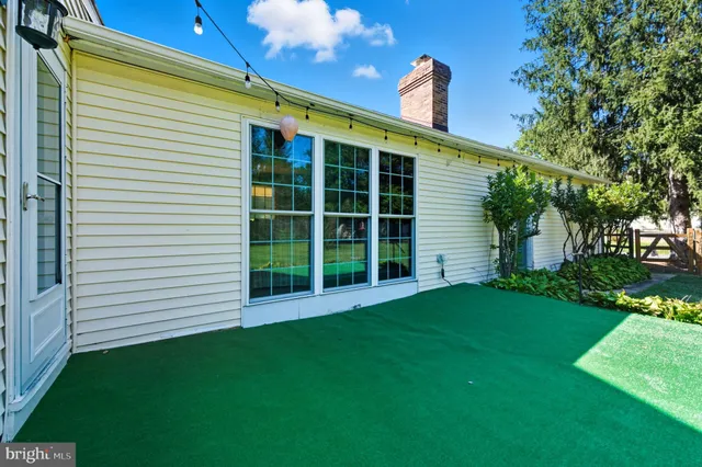 a view of green field with trees in the background