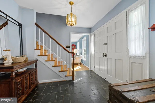 a view of an entryway with wooden floor and livingroom view