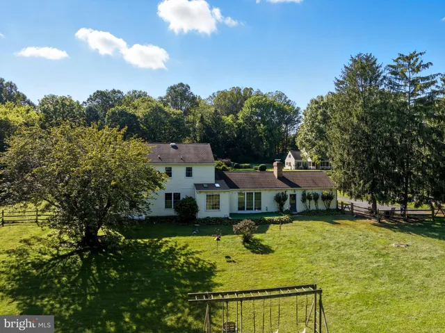 an aerial view of a houses with a yard