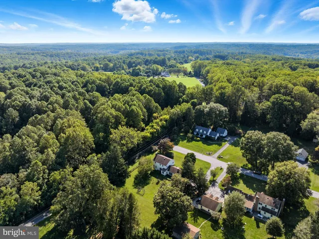 an aerial view of a houses with a yard