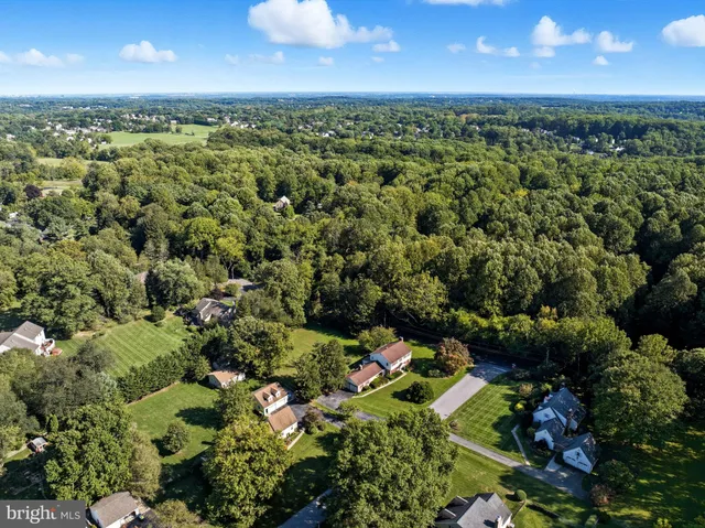an aerial view of a house with a yard swimming pool and outdoor seating