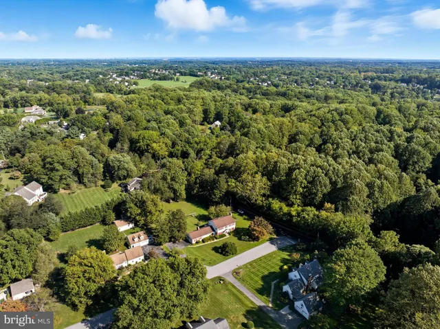 an aerial view of a houses with a yard
