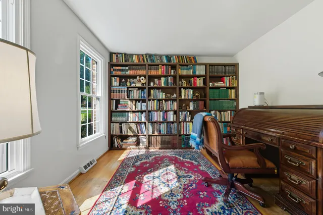 a living room with furniture and a book shelf