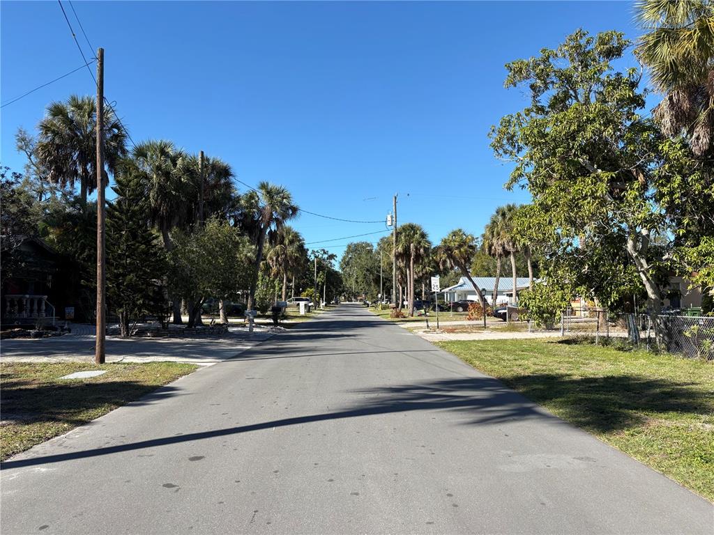1240 Highland Street Sarasota, FL 34234 - Photo 2 of 19 a view of a swimming pool and trees in the background