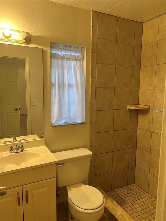 1240 Highland Street Sarasota, FL 34234 - Photo 6 of 19 a bathroom with a sink a toilet and shower
