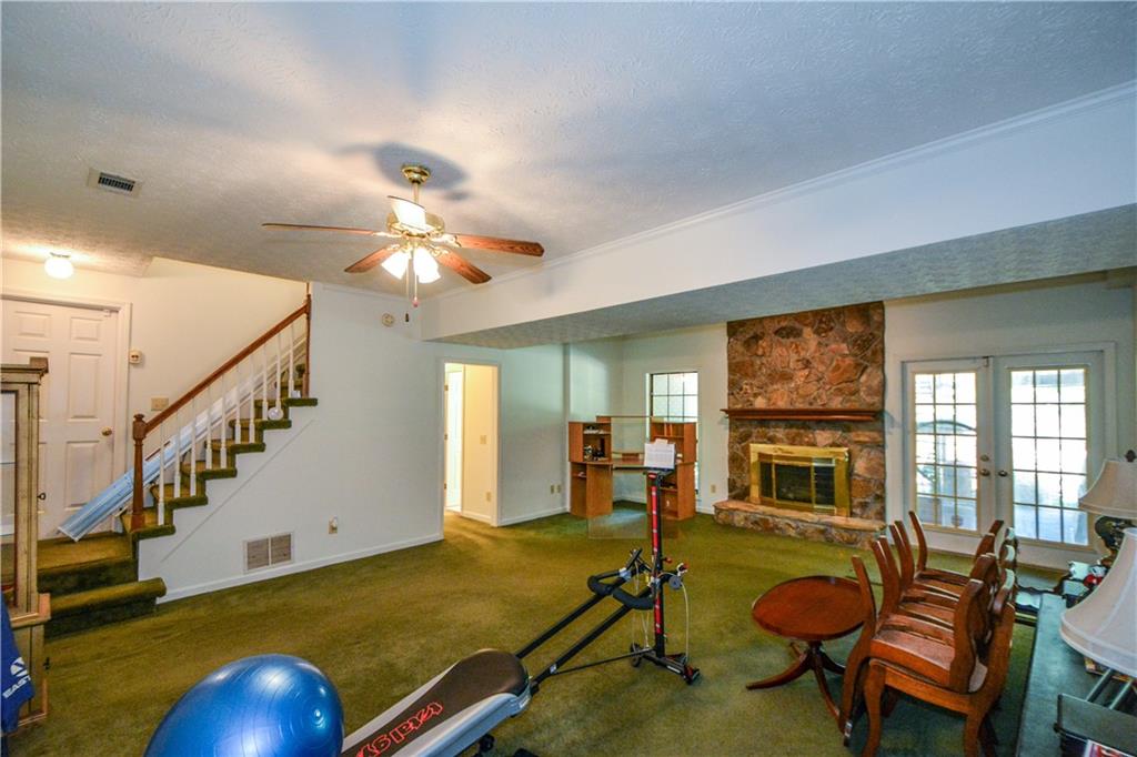 130 Hawn Road Fayetteville, GA 30215 - Photo 35 of 67 a living room with furniture pool table wooden floor and windows
