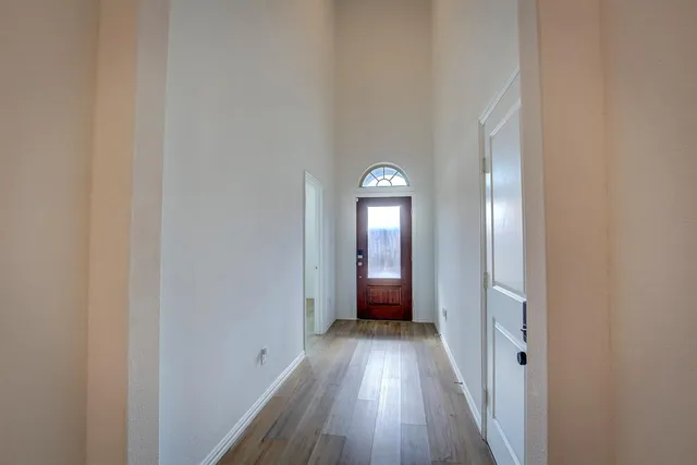 a view of a room with wooden floor