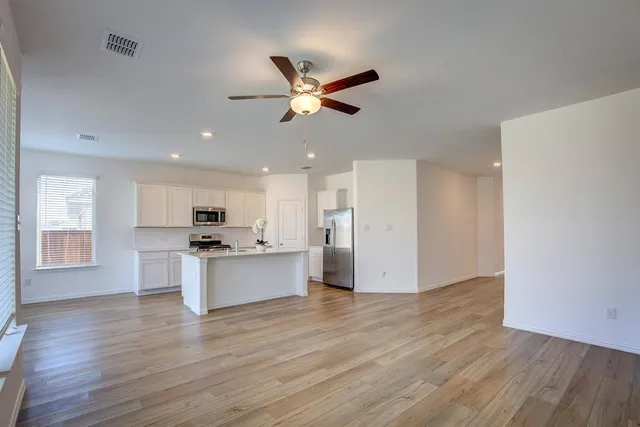 a view of kitchen with sink microwave and stove