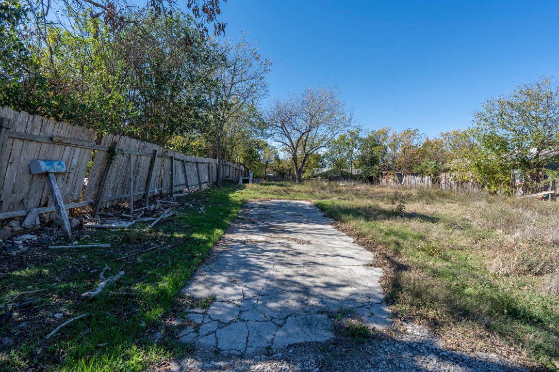 313 North Front Street Kyle, TX 78640 - Photo 22 of 28 a view of backyard with wooden fence and trees