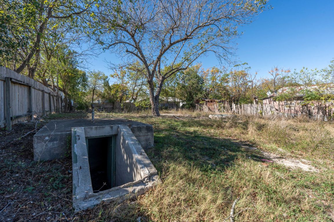 313 North Front Street Kyle, TX 78640 - Photo 23 of 28 a backyard of a house with large trees and outdoor seating