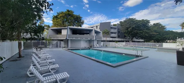 a view of a chairs and table in the back yard of the house