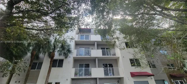a front view of a house with a tree