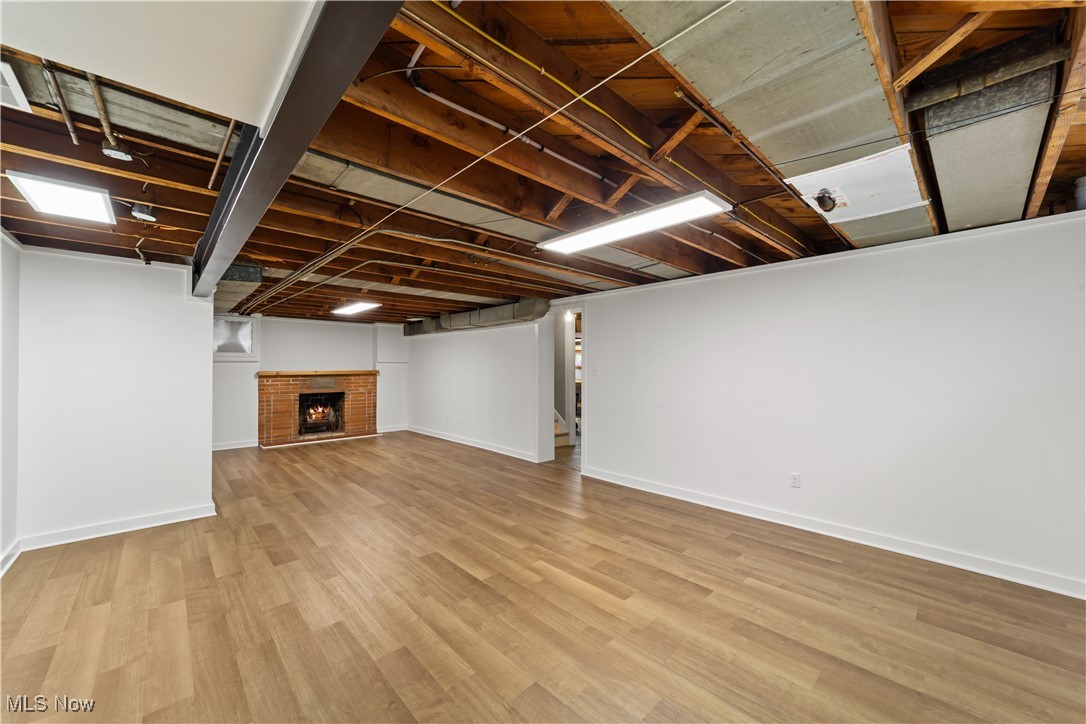 4648 Ammon Road Cleveland, OH 44143 - Photo 34 of 48 Basement with light wood-style flooring and a fireplace