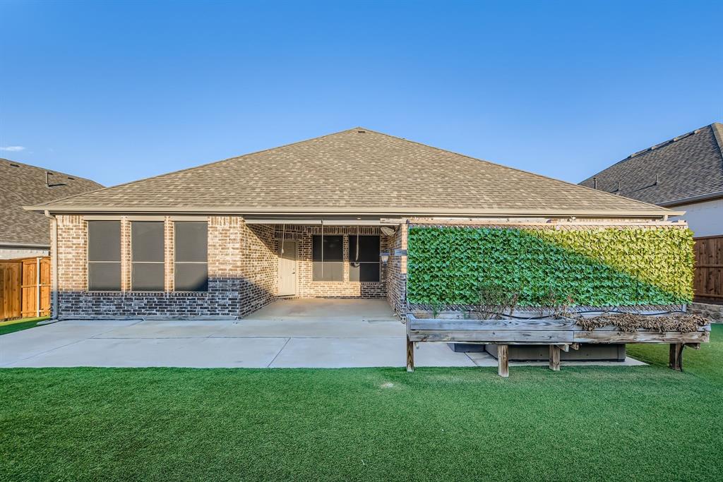 312 Magnolia Drive Oak Point, TX 75068 - Photo 28 of 28 Rear view of property featuring roof with shingles, a patio area, and brick siding