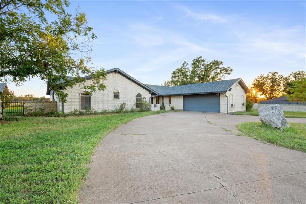 105 Riverside Drive Mineral Wells, TX 76067 - Photo 2 of 40 Single story home featuring concrete driveway, a garage, and brick siding