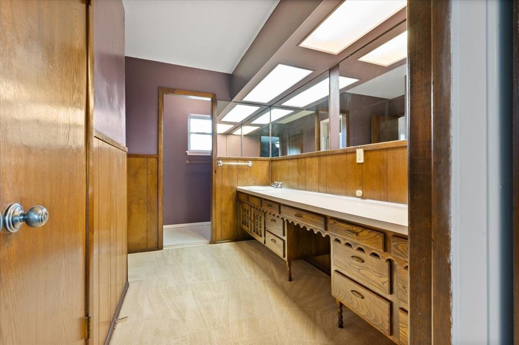 105 Riverside Drive Mineral Wells, TX 76067 - Photo 28 of 40 Bathroom with wooden walls, a wainscoted wall, and double vanity
