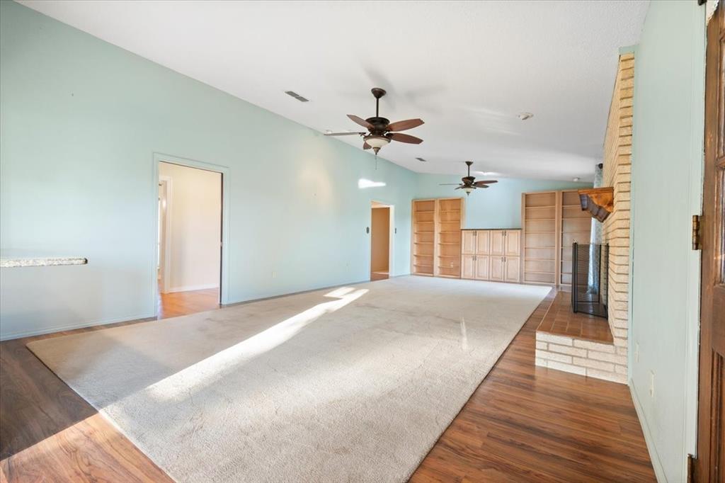105 Riverside Drive Mineral Wells, TX 76067 - Photo 9 of 40 Detailed view of a brick fireplace and wood finished floors
