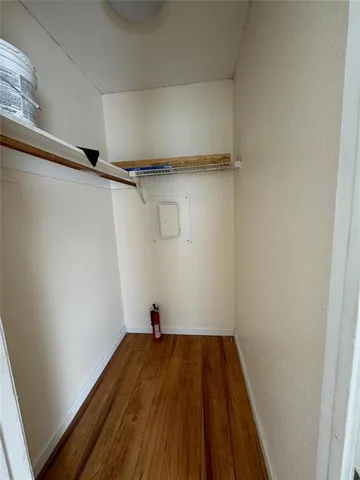 a view of a room with wooden floor