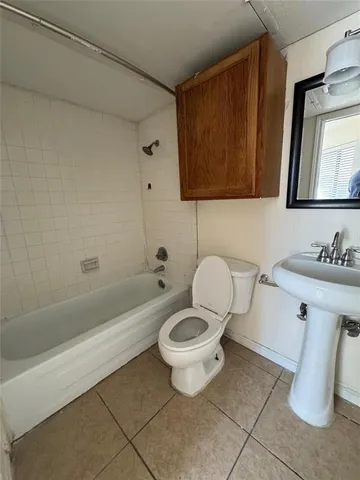a bathroom with a toilet a sink and bathtub