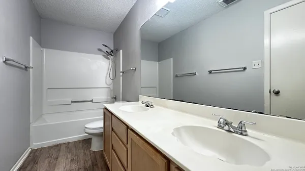 a bathroom with a sink toilet tub and shower