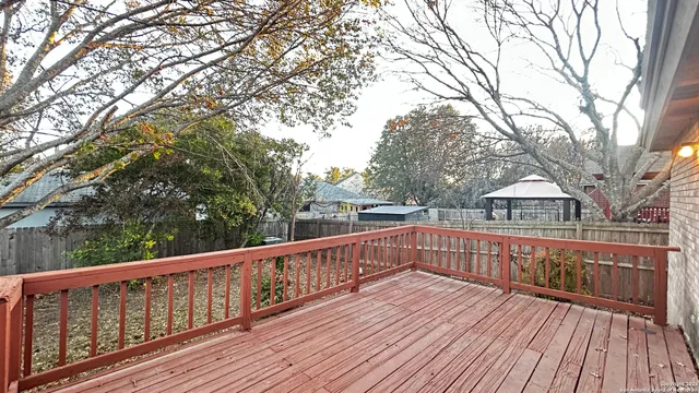 a view of balcony with wooden floor and fence
