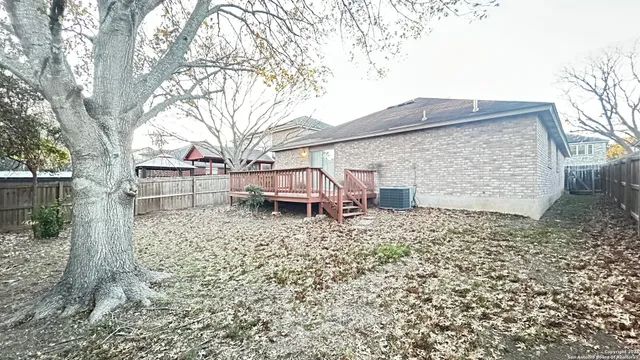 front view of a house with a large tree
