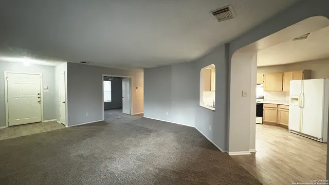 a view of a big room with windows and cabinet